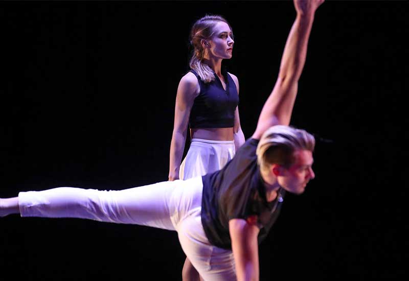two students dance onstage