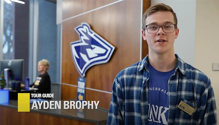 a photo of UNK Tour Guide Ayden Brophy with his name written out in the lower left corner