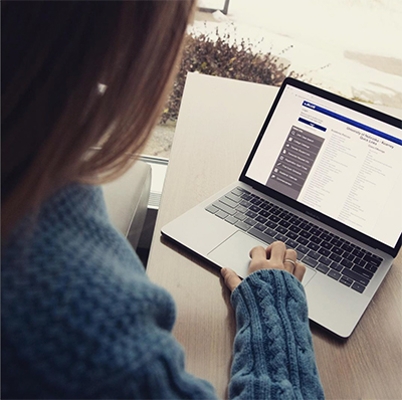 girl looking at a computer screen on my blue