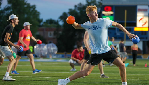 Students on the football field during a campus recreation event 