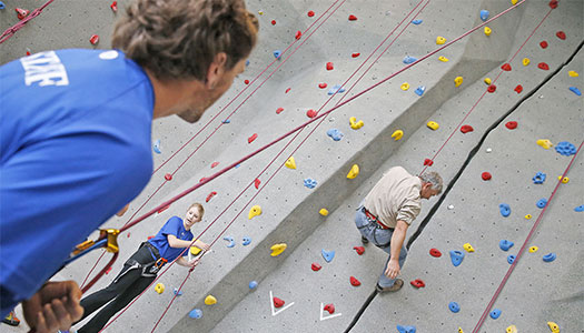 UNK student climbing the rock wall at the wellness center