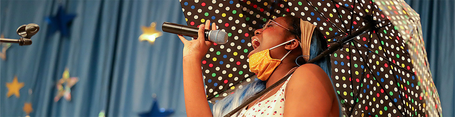 a student sings at a talent show