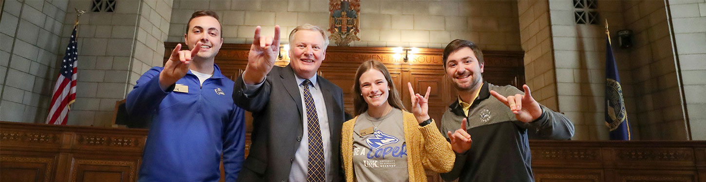 student government representatives pose with Chancellor Kristensen  at the state capitol