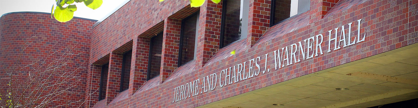 a picture of Warner hall. Sign reads: Jerome and Charles J Warner Hall