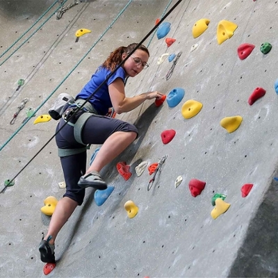 Student using the in door climbing wall