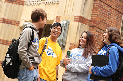 multi cultural students in front of office