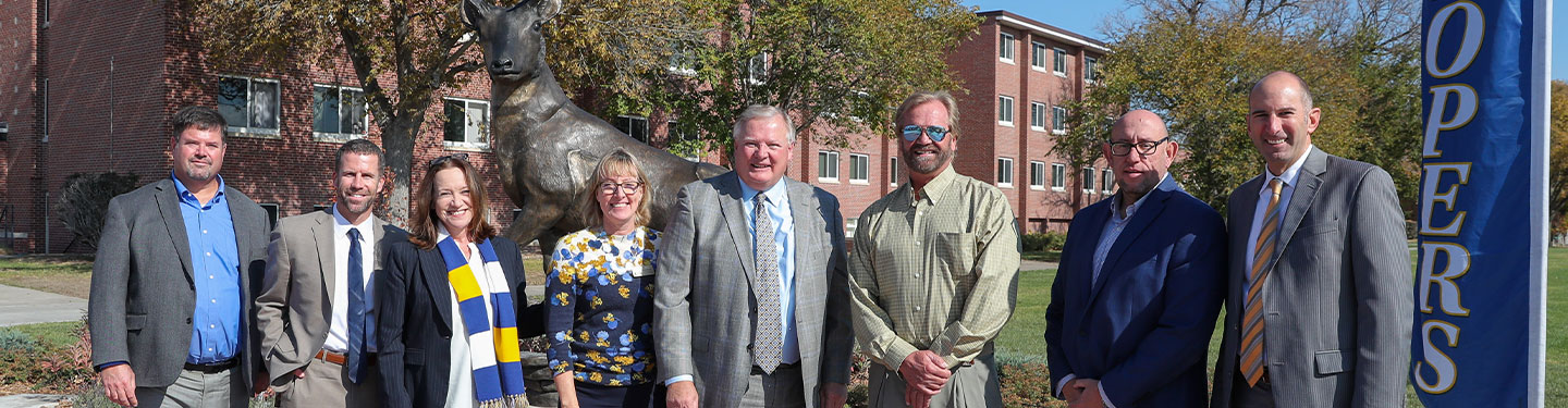 administration members gather in front of the loper statue for it's dedication