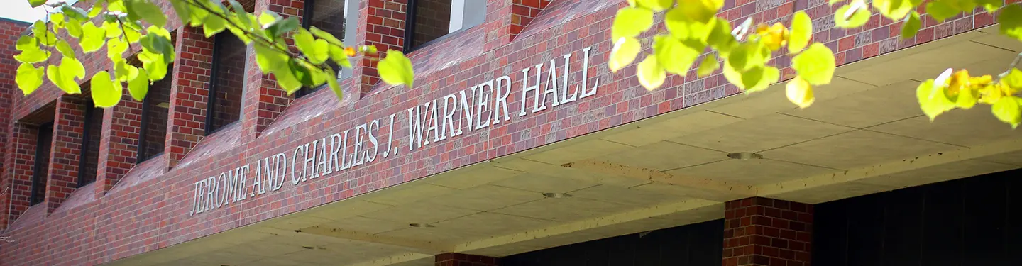 a picture of Warner hall. Sign reads: Jerome and Charles J Warner Hall