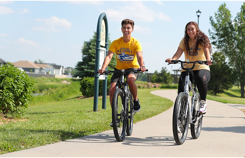 two students riding bikes on the Hike and Bike Trail