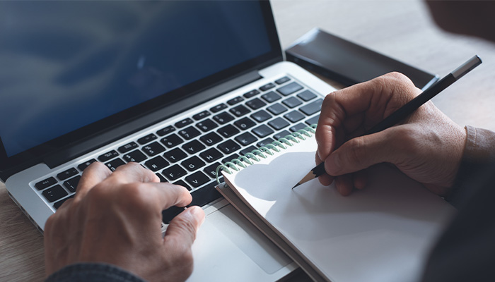 a notebook sits on top of a laptop keyboard