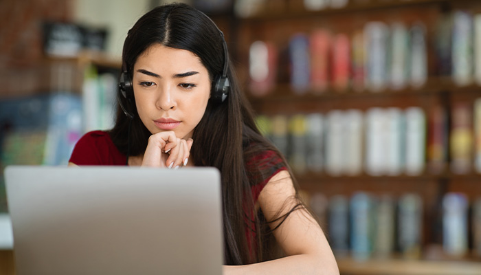 a woman works on a laptop