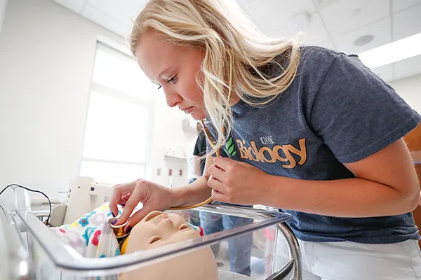 a student works with a medical dummy