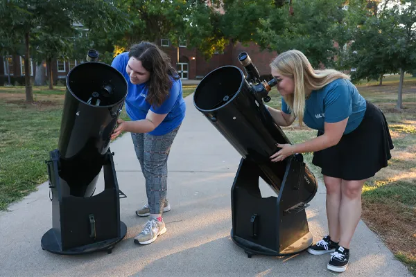 students set up telescopes on UNK's campus