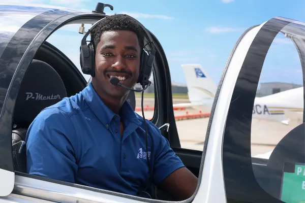 a student sits in a UNK Airplane