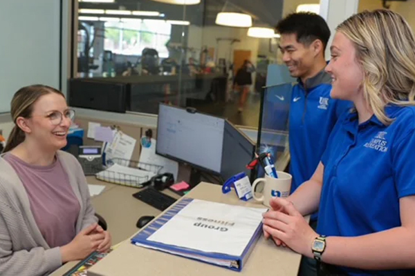 a man and woman talk desk attendant