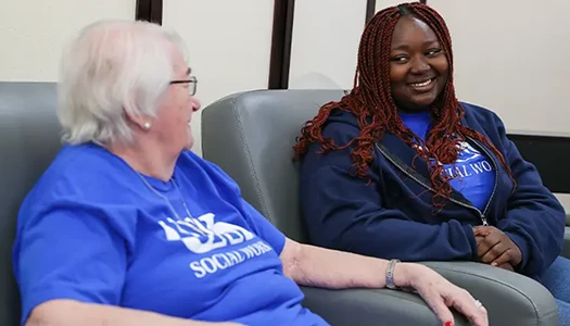 a student works with an elderly woman