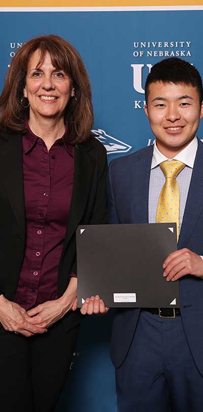Student Holding Award