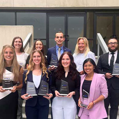 students from the FBLA club hold up awards