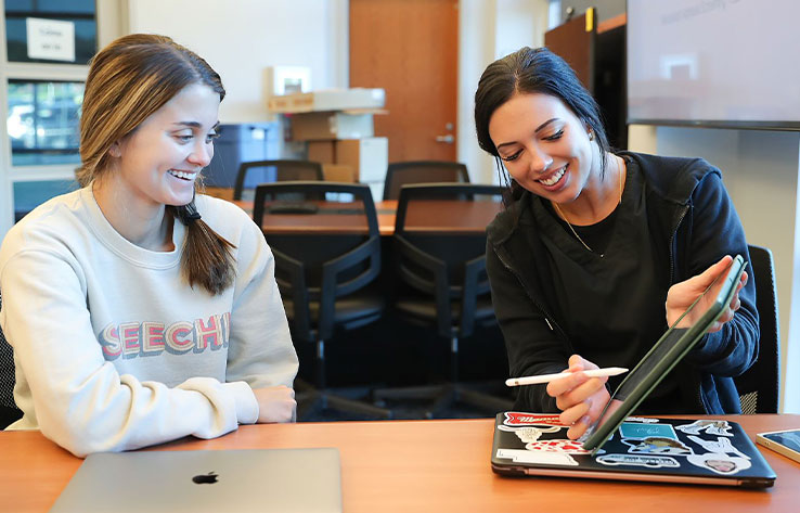 two students work together in a class