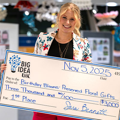 Fallon Wells holding a giant check