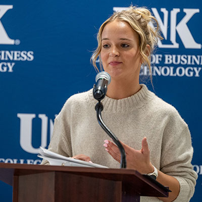 Jessica Bertrand speaking at a podium