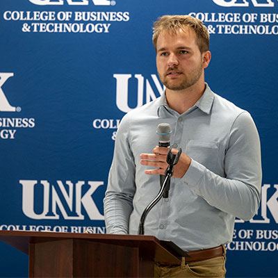 Kade Schrock speaking at a podium