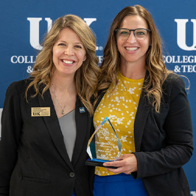 Award recipient poses with staff