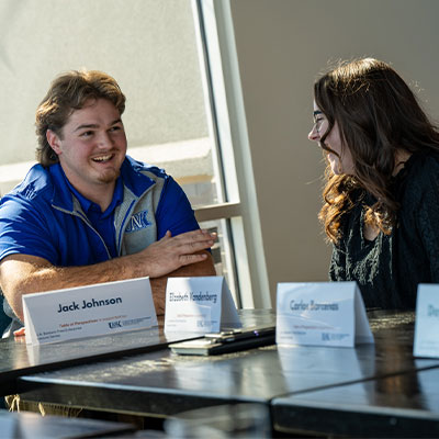 two people talk at a table