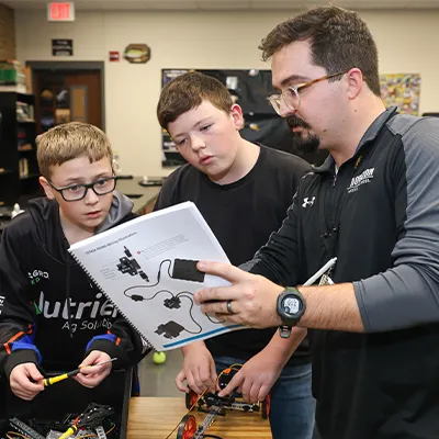 a teacher points to a student's textbook