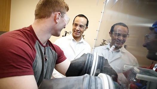 Student working in a lab with a faculty member