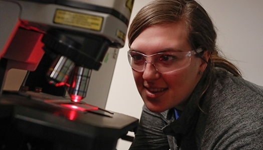 Student working with a microscope