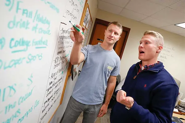 students write on a whiteboard