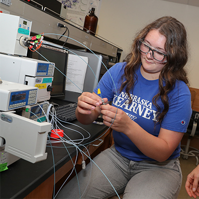 a student works with lab equipment