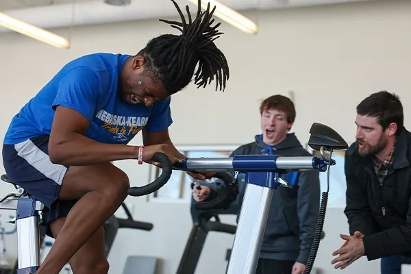a student and instructor do fitness testing on another student