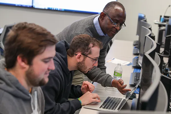an instructor works with students during a finance class