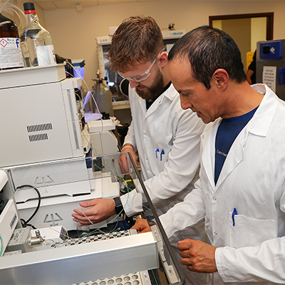 a student and professor work together in a lab