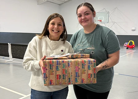 a worker is presented with gifts at a childcare center