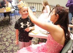 a child is given a crown at an event