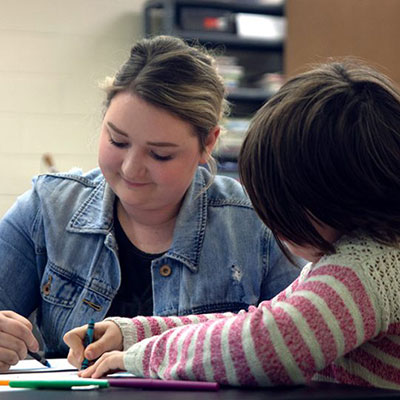 Teacher Coloring with a student