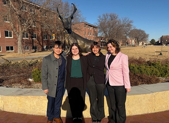 the unk forensics team poses for a photo in front of the antelope statue