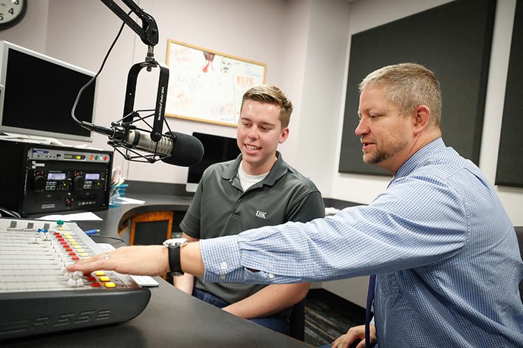 Student speaking into microphone