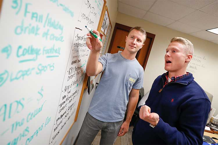 students working at a whiteboard