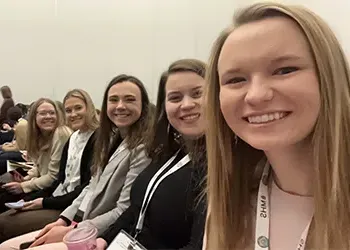 students take a selfie at a conference