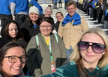 students and instructors take a selfie outdoors 