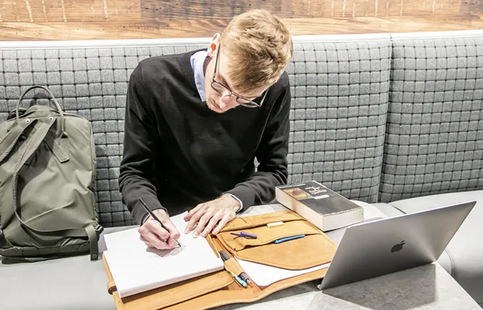 a student writes in a notebook