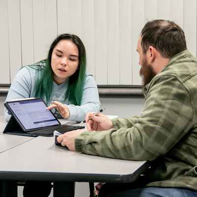 two unk student work at a computer