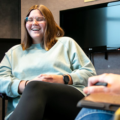 a student sits and laughs