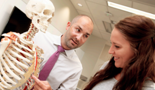Instructor showing a skeleton to a student