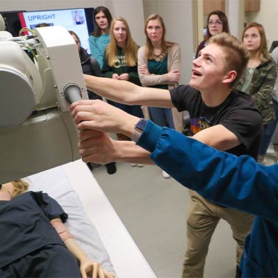 a student uses medical equipment during a demonstration