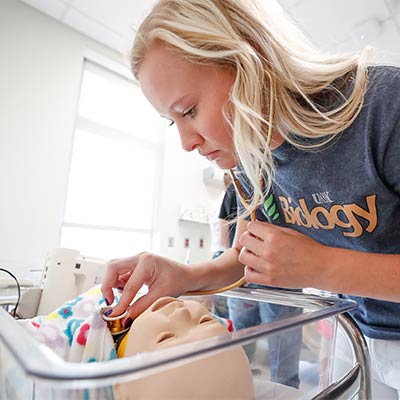 a student works with a dummy